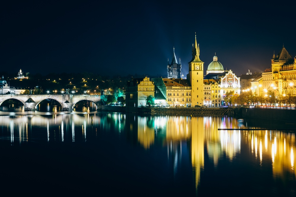 Charles Bridge and buildings along the Vltava at night, in Prague, Czech Republic..jpeg