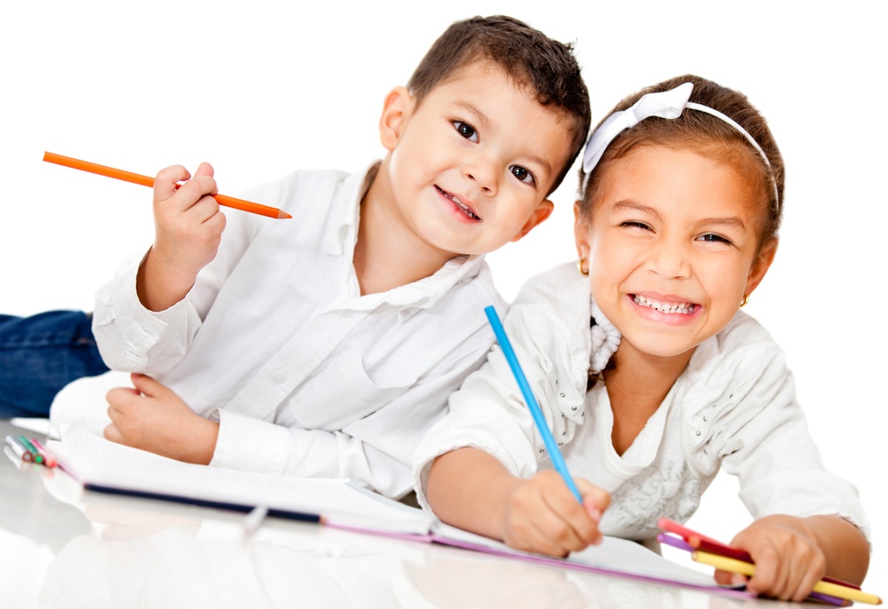 Happy kids smiling and coloring a book - isolated over white.jpeg